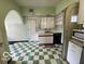 Cozy kitchen featuring retro checkerboard floors and tiled archways at 302 E Main St, Greenfield, IN 46140