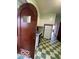 Retro kitchen features white appliances, green tile trim and a checkerboard floor at 302 E Main St, Greenfield, IN 46140
