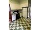 Retro kitchen features white appliances, green tile trim and a checkerboard floor at 302 E Main St, Greenfield, IN 46140