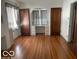 Open living room with hardwood floors and a quaint built in vanity in an archway at 302 E Main St, Greenfield, IN 46140