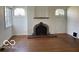 Living room with hardwood floors, fireplace, and neutral paint at 302 E Main St, Greenfield, IN 46140
