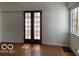 Hardwood floor living room with natural light, traditional windows and double doors at 302 E Main St, Greenfield, IN 46140
