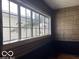 Room featuring large window, tiled molding, and patterned wallpaper at 302 E Main St, Greenfield, IN 46140