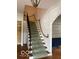 Carpeted staircase with unique rope railing and wrought iron banister leading to the second level at 302 E Main St, Greenfield, IN 46140