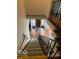 View of foyer with black and white tile from top of staircase with green carpet and wrought iron banister at 302 E Main St, Greenfield, IN 46140