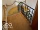 Carpeted staircase with wrought iron railing and rope decor at 302 E Main St, Greenfield, IN 46140