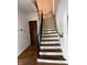 A charming staircase featuring wrought iron railings and a unique rope accent for a touch of nautical style at 302 E Main St, Greenfield, IN 46140