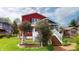 Beautiful backyard featuring a brick walkway, flowering trees, and a screened-in porch at 319 N Ridgeview Dr, Indianapolis, IN 46219