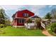 Well-maintained backyard featuring mature trees and a covered porch with white railing at 319 N Ridgeview Dr, Indianapolis, IN 46219