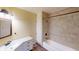 Well-lit bathroom featuring tile surround, vanity and ample storage at 319 N Ridgeview Dr, Indianapolis, IN 46219