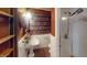 Unique bathroom with vanity sink and shower, and walls decorated with wallpaper made of vintage books at 319 N Ridgeview Dr, Indianapolis, IN 46219