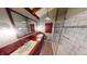 Bright bathroom with double sinks, wood floors, walk-in shower, and a large mirror at 319 N Ridgeview Dr, Indianapolis, IN 46219