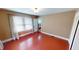 A bedroom with wood floors, a white door and window with blinds allowing for natural light and privacy at 319 N Ridgeview Dr, Indianapolis, IN 46219