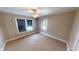 Inviting bedroom with carpet, neutral walls, and well-lit window creating a cozy atmosphere at 319 N Ridgeview Dr, Indianapolis, IN 46219