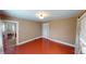 An empty bedroom featuring hardwood flooring, neutral wall paint, and a closet for storage at 319 N Ridgeview Dr, Indianapolis, IN 46219