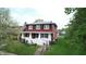 Charming two-story home featuring a cozy front porch and well-maintained landscaping at 319 N Ridgeview Dr, Indianapolis, IN 46219