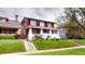 Classic two-story house with a red exterior, white trim, and a well-manicured front lawn at 319 N Ridgeview Dr, Indianapolis, IN 46219