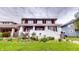 Charming two-story home with lush landscaping, brick foundation, and covered front porch at 319 N Ridgeview Dr, Indianapolis, IN 46219
