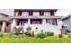 Inviting two-story home with a brick foundation, front porch, and verdant landscaping at 319 N Ridgeview Dr, Indianapolis, IN 46219