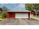 Two-car detached garage featuring a large white door and ample driveway space at 319 N Ridgeview Dr, Indianapolis, IN 46219
