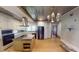Bright kitchen with white cabinets, stainless appliances, center island, and decorative tin tile ceiling at 319 N Ridgeview Dr, Indianapolis, IN 46219