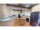 Bright kitchen features white cabinets, stainless appliances, center island, and decorative tin tile ceiling at 319 N Ridgeview Dr, Indianapolis, IN 46219