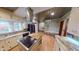 Bright kitchen features white cabinets, stainless appliances, center island, and decorative tin tile ceiling at 319 N Ridgeview Dr, Indianapolis, IN 46219