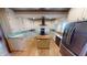 Bright kitchen with white cabinets, stainless appliances, center island, and decorative tin tile ceiling at 319 N Ridgeview Dr, Indianapolis, IN 46219