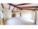 Bright living room showcasing exposed beams, neutral carpet, and large windows at 319 N Ridgeview Dr, Indianapolis, IN 46219