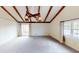 Airy living room boasting exposed beam ceiling, neutral carpet, and natural light at 319 N Ridgeview Dr, Indianapolis, IN 46219