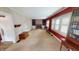 Inviting living room featuring a brick fireplace, built-in shelving, and natural light from large windows at 319 N Ridgeview Dr, Indianapolis, IN 46219