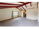 Large living room features exposed beams, carpet, and large window views at 319 N Ridgeview Dr, Indianapolis, IN 46219