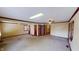 Spacious living room featuring neutral carpet, wood trim, ceiling fan, and natural light from several windows at 319 N Ridgeview Dr, Indianapolis, IN 46219