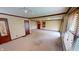 Inviting living room featuring neutral carpet, wood trim, ceiling fan, and natural light from several windows at 319 N Ridgeview Dr, Indianapolis, IN 46219