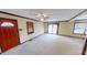 Cozy living room featuring neutral carpet, wood trim, ceiling fan, and natural light from sliding glass doors at 319 N Ridgeview Dr, Indianapolis, IN 46219
