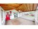 Spacious screened-in porch with wood flooring, ceiling fan, and sliding door to backyard at 319 N Ridgeview Dr, Indianapolis, IN 46219