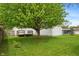 View of home's backyard featuring lush green grass and a deck at 327 S Biltmore Ave, Indianapolis, IN 46241