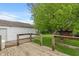 View of the deck overlooking the well maintained backyard and tree at 327 S Biltmore Ave, Indianapolis, IN 46241
