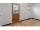Cozy room with a wood door and natural light from the window at 327 S Biltmore Ave, Indianapolis, IN 46241