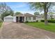 Charming single-story home featuring a spacious front yard and detached garage at 327 S Biltmore Ave, Indianapolis, IN 46241
