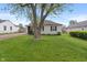 Beautifully maintained front lawn and mature trees surround the charming single-story house at 327 S Biltmore Ave, Indianapolis, IN 46241