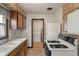 Traditional kitchen featuring wood cabinets and an opening leading to the laundry area at 327 S Biltmore Ave, Indianapolis, IN 46241