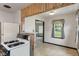Cozy kitchen with white appliances, warm wood paneling, and natural light at 327 S Biltmore Ave, Indianapolis, IN 46241