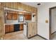 Kitchen has wood cabinets, laminate countertop and white appliances at 327 S Biltmore Ave, Indianapolis, IN 46241