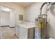 Functional laundry room with washer, dryer, and water heater at 327 S Biltmore Ave, Indianapolis, IN 46241