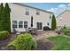 Spacious backyard with stone patio, seating area, and lush green landscaping at 3430 Burlingame Blvd, Westfield, IN 46074