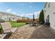 Backyard with a stone patio, green lawn, and a black metal fence at 3430 Burlingame Blvd, Westfield, IN 46074
