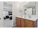 Bathroom with double vanity, a large mirror, wood cabinets and a view to the main bedroom at 3430 Burlingame Blvd, Westfield, IN 46074