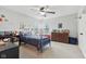 Bedroom features a blue bed, ceiling fan, and dresser at 3430 Burlingame Blvd, Westfield, IN 46074