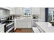 Bright kitchen featuring white cabinets, stainless steel appliances, and stone countertops at 3430 Burlingame Blvd, Westfield, IN 46074